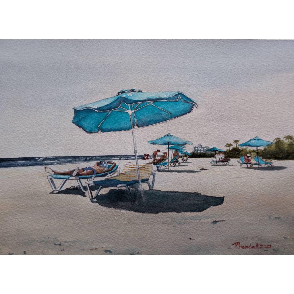 A man with a towel over his head peacefully taking a nap under a blue umbrella while on vacation at Lido Beach Sarasota, Florida